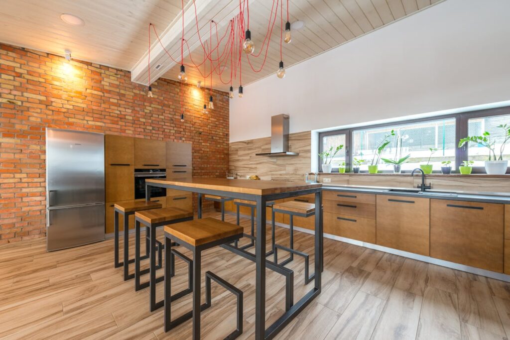 Spacious and stylish kitchen featuring modern industrial design with wooden and metal elements.